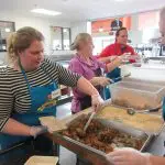 Merjent team members volunteering to make and pack meals for Open Arms of Minnesota. Food to be donated to people battling chronic and terminal illness. Company sponsored volunteer event with paid volunteer time. Michaela Swanson, Kim Jessen, Rob Jones, and Melissa Dellwo, in photo from left to right.